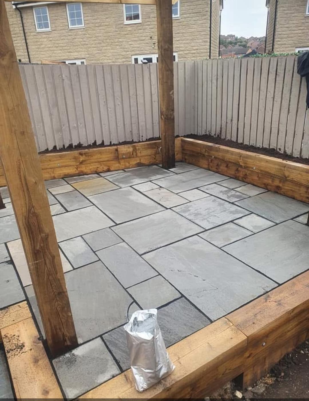 Indian sandstone patio with sleeper edging