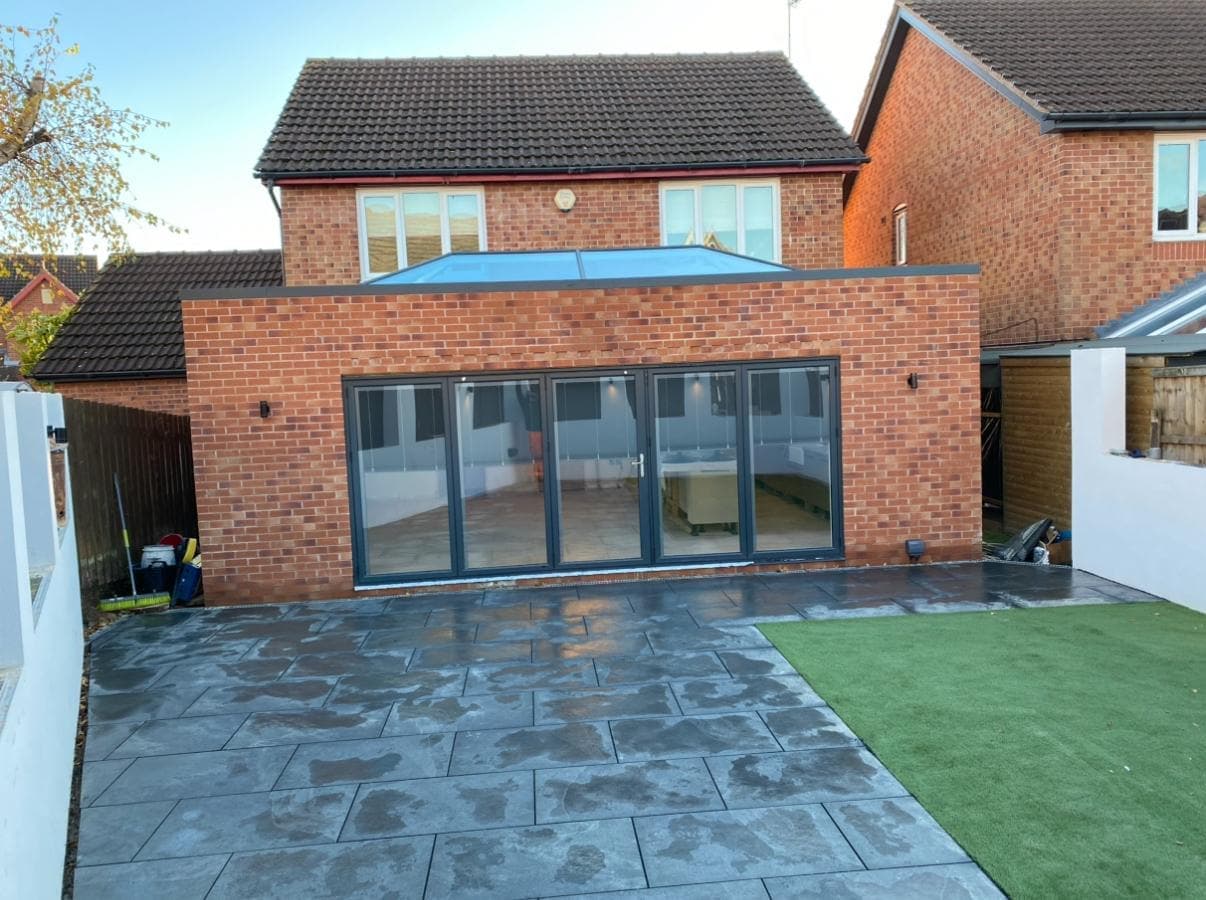 Extension with bifolds onto a new porcelain patio