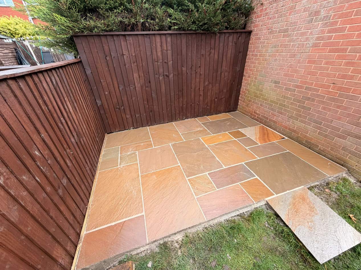 Indian sandstone patio in an enclosed yard