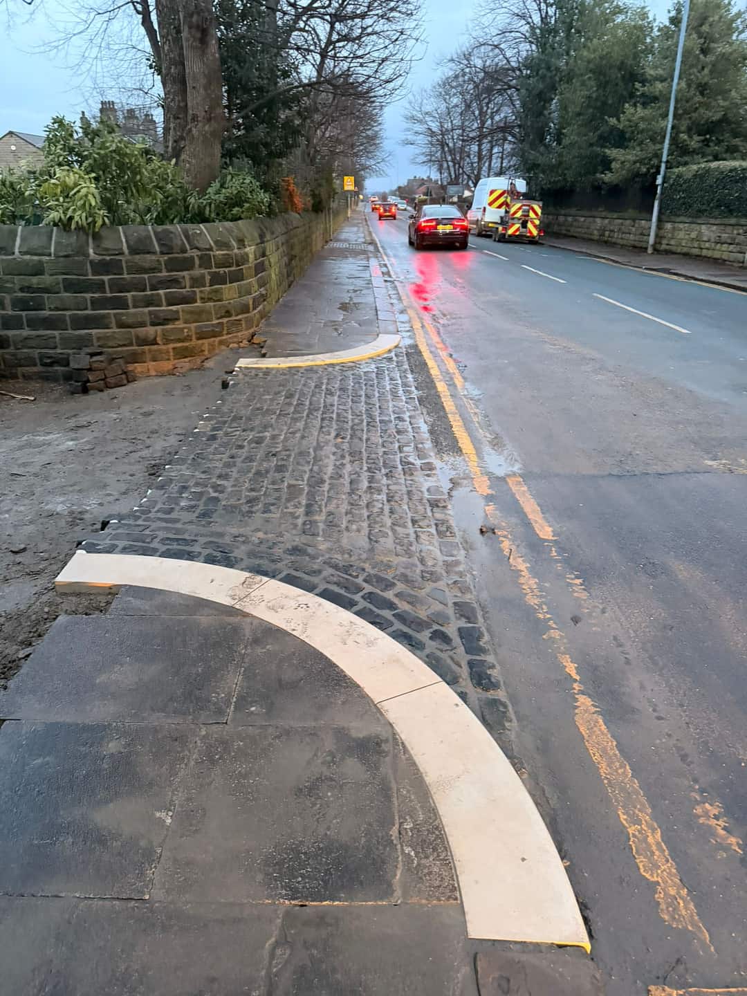 New kerb line and setts alongside a live road