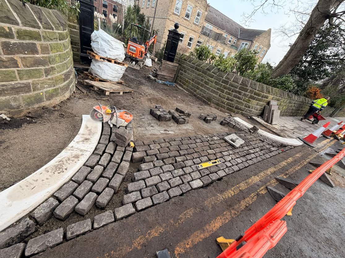 Granite setts and kerbing to a retaining wall